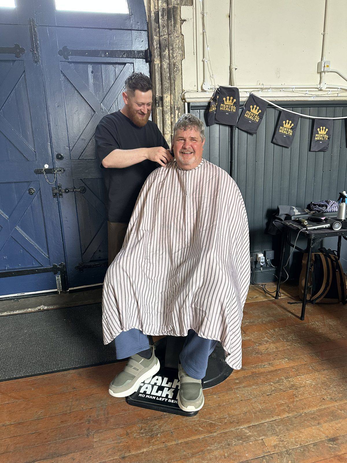 A visitor getting a free haircut at Mental Wealth 2026, one of the event's other attractions alongside the ice bath workshop